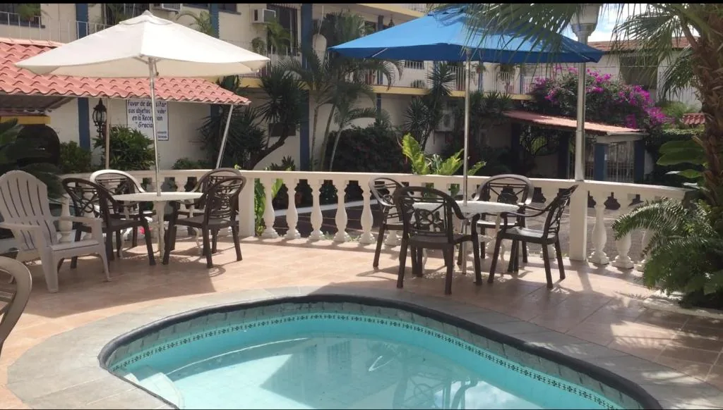 Sunny pool terrace with outdoor seating